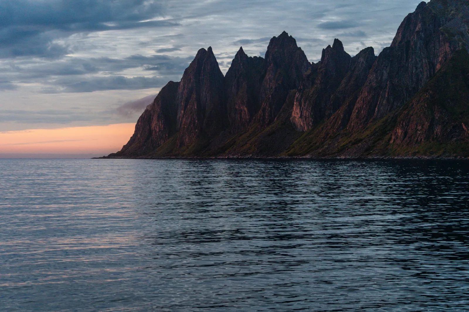 The jagged Okshornan peaks, known as Djevelens Tanngard, rising from the coast at Tungeneset