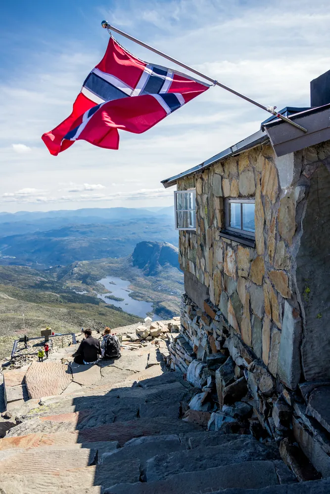 Gaustatoppen Tourist Cabin and Norwegian flag near the summit