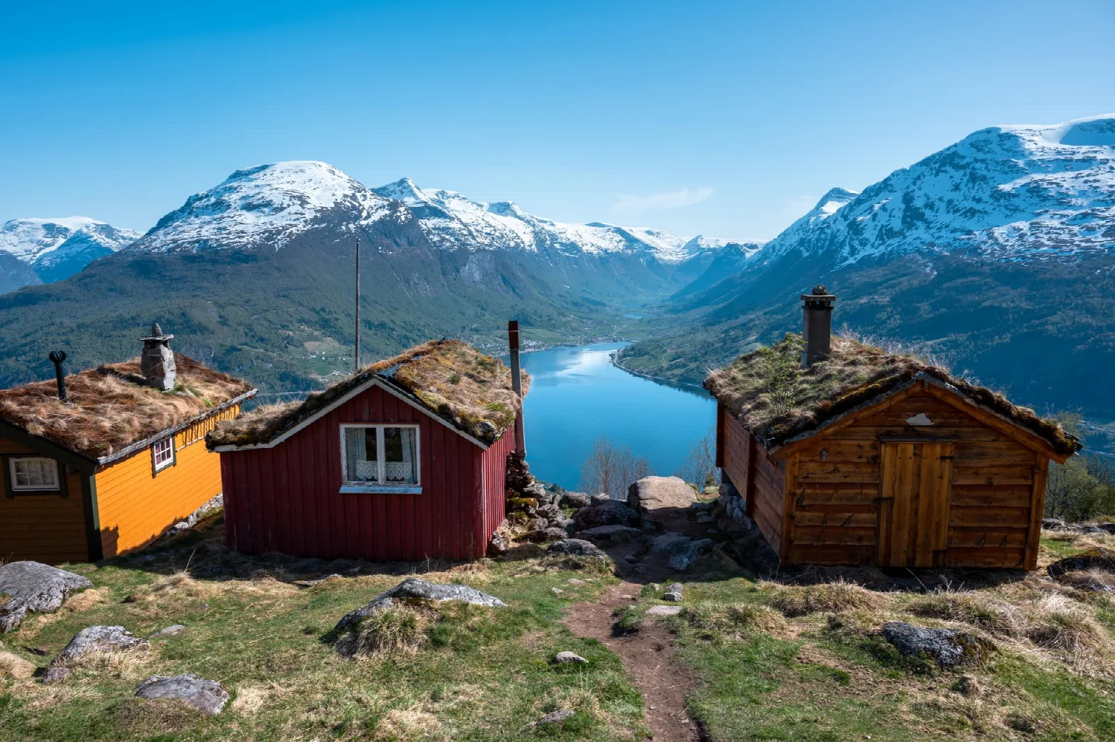 Grass-roofed cabins at Rakssetra overlooking the fjord and mountains near Loen