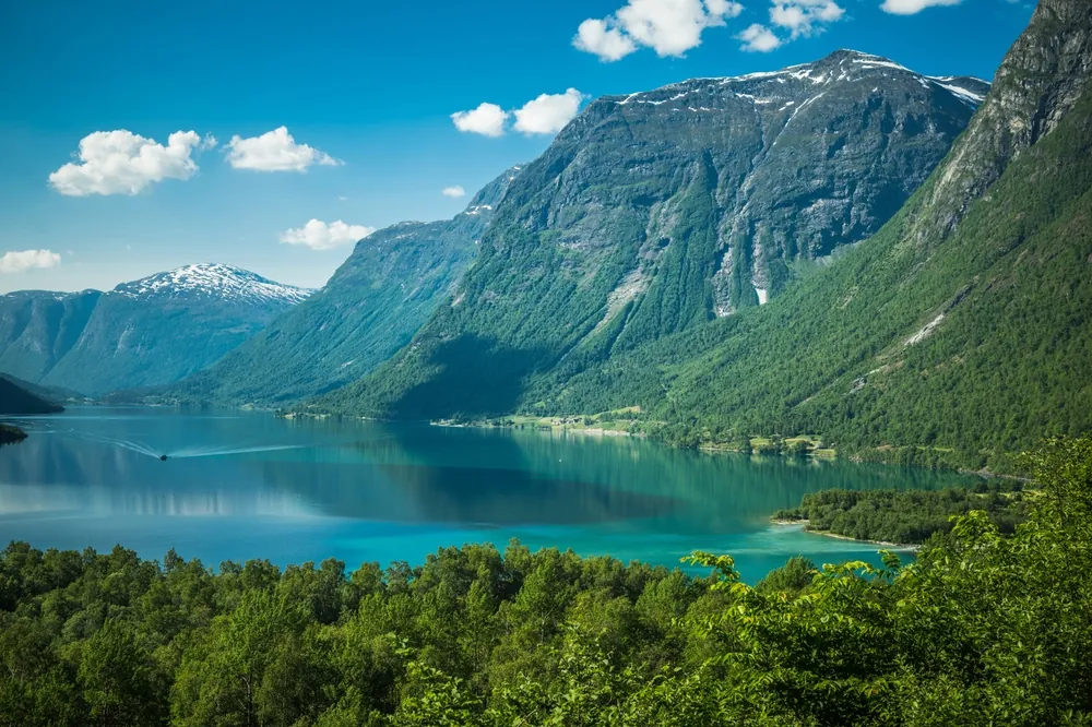 Turquoise Lovatnet between steep mountains in Lodalen near Kjenndalsbreen