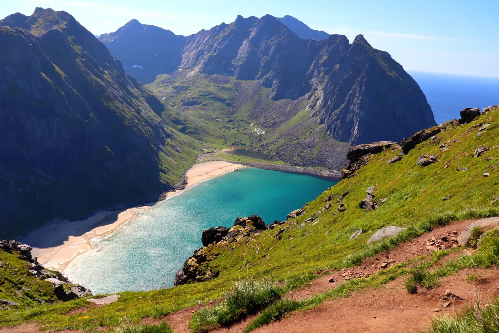 Kvalvika Beach and its turquoise bay enclosed by steep mountains on Moskenesøya