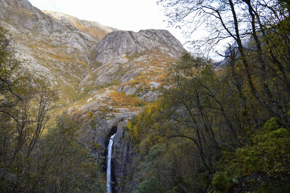 Månafossen in autumn woodland and rocky terrain