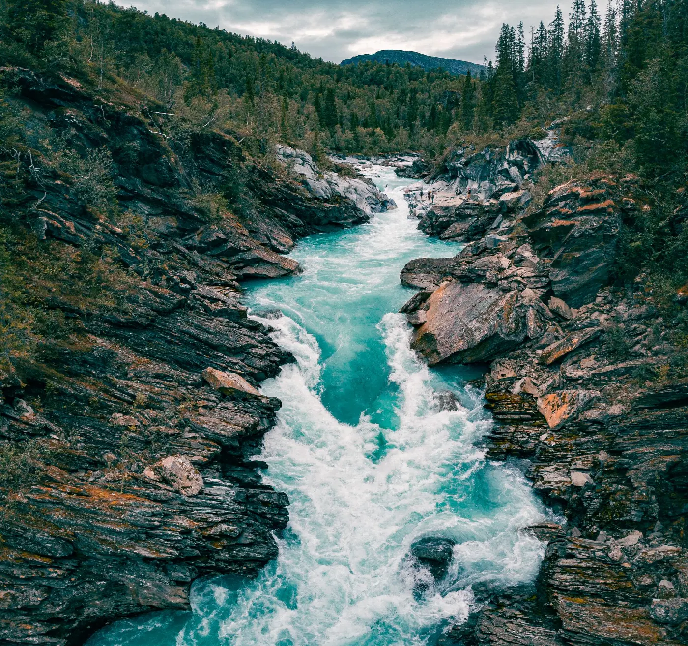 Turquoise water rushing through the sculpted rock channel at Marmorslottet near Mo i Rana
