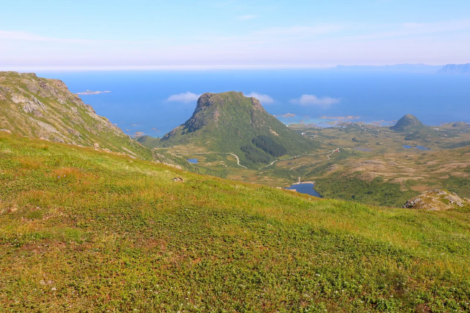 View from the Måtinden slopes across the green mountains and open Atlantic coast of Andøya